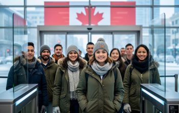 Diverse international applicants in winter clothing standing at a Canadian admissions checkpoint with a blurred Canada-themed background.