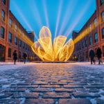 Winter night in Toronto’s Distillery Historic District with glowing light installations and warm reflections on snowy cobblestones.